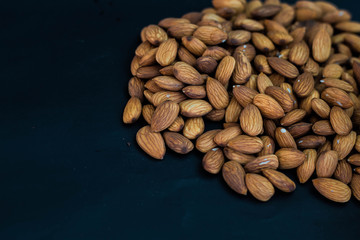 close up almonds nuts on black background
