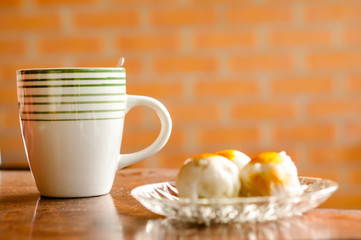 Cup of coffee and moon cake on a wooden table