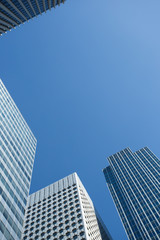 Obraz premium Skyscrapers with glass facade. Modern buildings in Paris business district. Concepts of economics, financial, future. Copy space for text. Dynamic composition. Toned