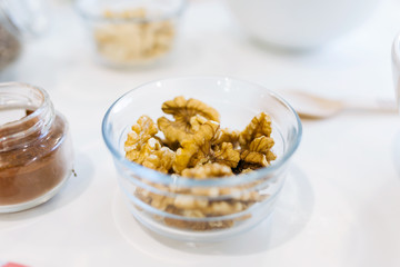 Walnuts in a bowl and cacao in the kitchen.