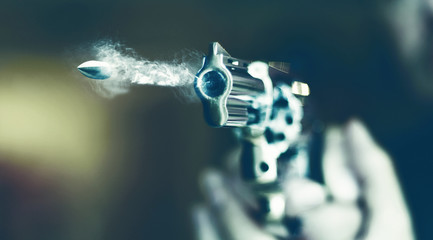 hand gun revolver with flying bullet fire