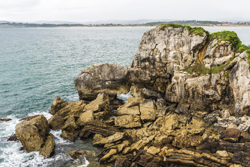 Rocky coastline along cliffs in Santander, Spain