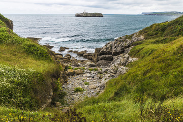 Fototapeta na wymiar Rocky coastline along cliffs in Santander, Spain