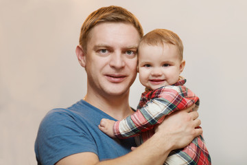 Happy father plays with his baby at home

