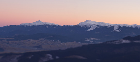 Beautiful mountains landscape at sunset with blured foreground