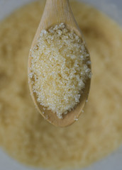 closeup sugar on wooden spoon