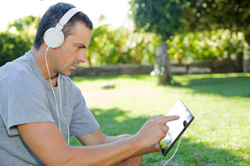 Fototapeta premium man relaxing with tablet pc