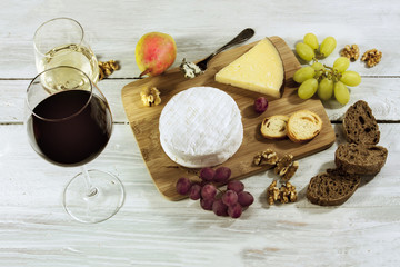 Photo of wine, cheese, grapes, nuts, bread at tasting