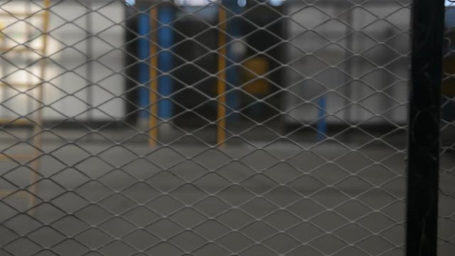 Wire fence. Closeup of steel net. Steel mesh. Security protection. Fence made from steel wire. Net background. Metallic security net