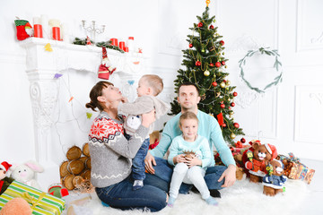 Modern family mother father daughter son christmas winter portrait. Decorated christmas tree, cozy atmosphere living room. Family Together Celebration Concept. Merry Christmas and Happy Holidays. 