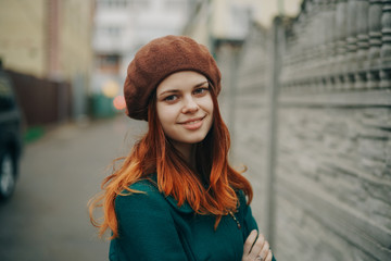 red-haired woman in beret, walk, street, cloudy weather, lifestyle