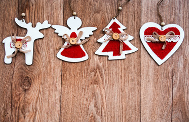 shabby chic christmas background with wooden and fabric red and white decorations on a rustic wooden table 