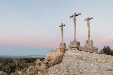 three crosses carved in the stone on fund to the evening