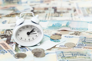 Time is money. Clock- Service on the background of Russian money