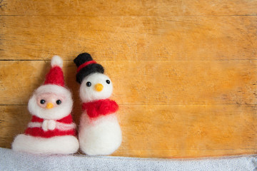 Top view or flat lay of cute santa claus and snowman doll decora