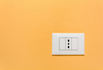 Empty Wall Socket on an Orange Wall