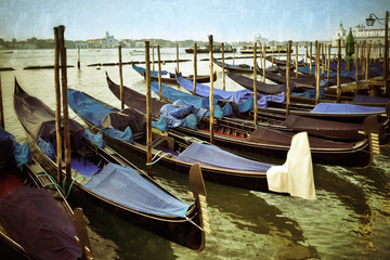Gondolas moored by Saint Mark square at sunrise. Venice, Italy. Filtered image, vintage effect applied