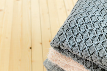 Stack of white cozy knitted sweaters