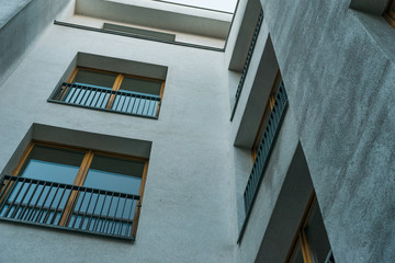 Fototapeta premium very low angle view of building with white facade and brown framed windows