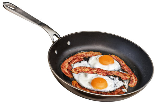 Sunny Side Up Eggs Fried with Bacon Rashers in Old Frying Pan Isolated On White Background