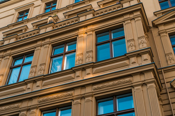 orange facade with ornaments and blue windows