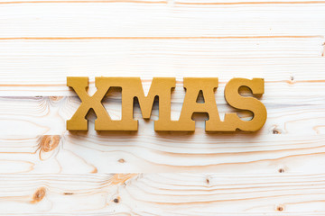 Christmas decoration with word xmas on wooden background, top view, flat lay.