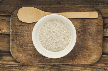 Rice in a plate with spoon. Ready for cooking. Healthy food.