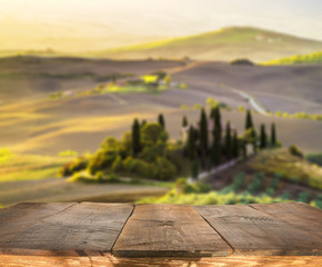 Naklejka na ściany i meble empty wooden table and Tuscan landscape at sunrise