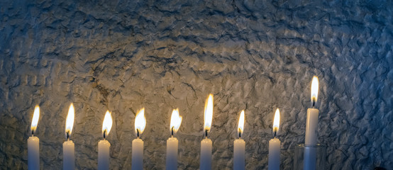 Glitter light of candles as traditional symbol for Hanukkah holiday 