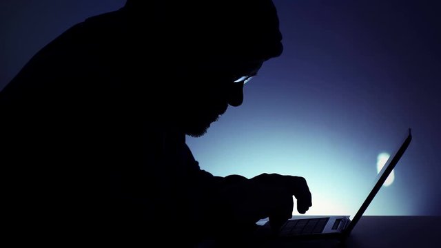 hacker at work with notebook computer