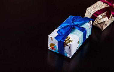 Gifts basket and candle against black background