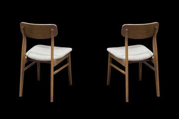 Wooden chairs on black background.