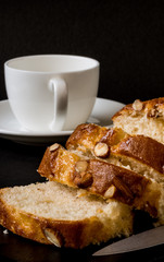 Almond cake, sliced, on black background