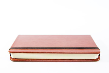 Small brown notebook isolated in white background.
