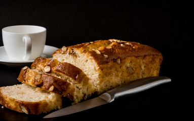 Almond cake, sliced, on black background