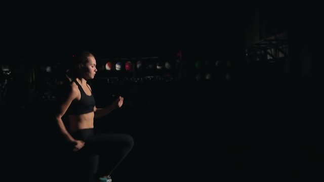 A girl running in place in the gym - fitness / crossfit / exercise / workout / runner / running
