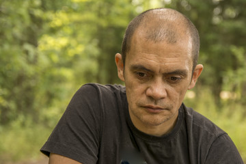 portrait of a pensive man outdoors