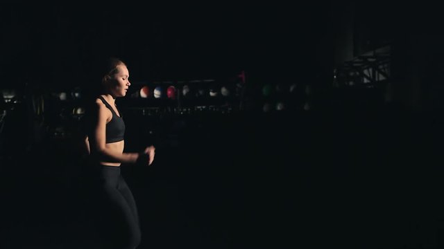 A girl running in place in the gym - fitness / crossfit / exercise / workout / runner / running