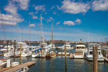 Fototapeta na wymiar Pier of Boston Wharf with sail boats in Charles River