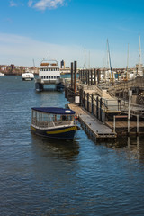 Fototapeta premium Pier of Boston Wharf with sail boat and Charles River