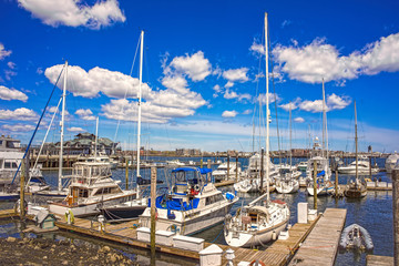 Pier of Boston Wharf with sailboats in Charles River