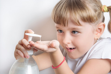 girl squirts liquid soap into hands