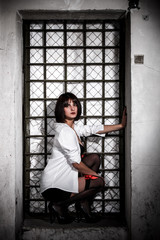 Sexy woman near the old lattice