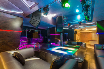 Interior of a night club with a pole