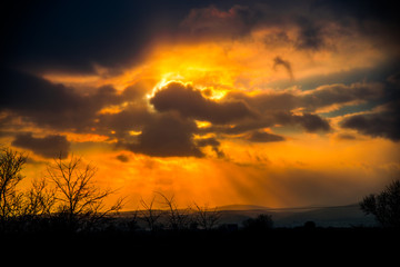 Naklejka premium Dramatic clouds at the sunset