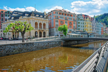 Fototapeta na wymiar Opera House and Bridge over Tepla River in Karlovy Vary