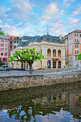 Fototapeta na wymiar Opera House at Tepla River of Karlovy Vary