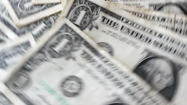 money, dollars, greenbacks rotating, spinning, turning round, rolling