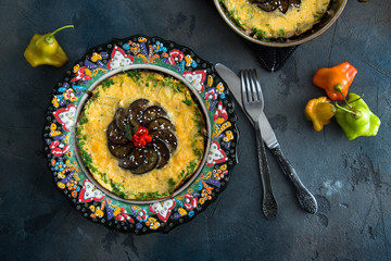 tasty omelet or badimjan chihirtmasi with eggplant, red onion and peper sprinkled  parsley on beautiful traditional plate, Azerbaijan