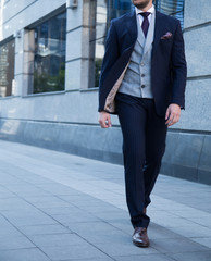 Male model in a suit walking the street